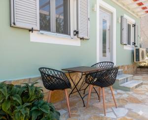 a patio with a table and two chairs at Electra Gaios Apartment in Gaios