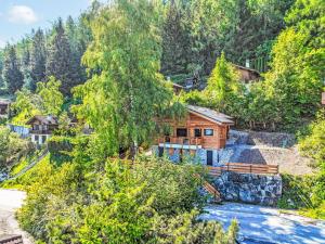 a log cabin in the woods next to a river at Chalet Byzance by Interhome in Nendaz