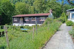 a house with a fence in front of it at BodeBude in Thale