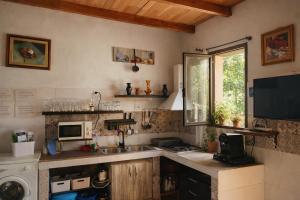a kitchen with a sink and a microwave at Casa El Filali in Villaminaya