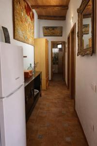a kitchen with a white refrigerator and a hallway at Casa El Filali in Villaminaya +2 photos