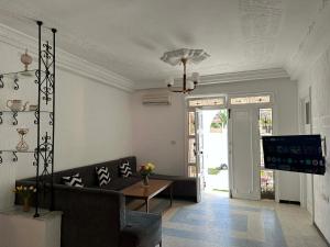 a living room with a couch and a tv at villa Flamingo in Sousse