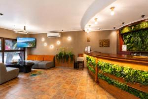 a lobby of a restaurant with a bar at Hotel Orbita in Varna City