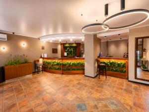 a lobby with a bar with plants at Hotel Orbita in Varna City