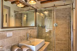 a bathroom with a sink and a shower at CASALE DEI GELSOMINI 8, Emma Villas in Todi +54 photos