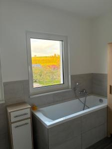 a bath tub in a bathroom with a window at Hedwig und Anna in Zapfendorf +16 photos