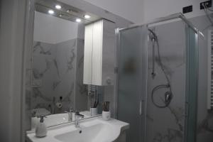 a bathroom with a sink and a glass shower at La Torretta in Savona