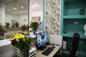 an office with a desk with a computer and flowers at La Torretta in Savona +45 photos