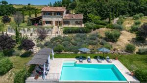an aerial view of a house with a swimming pool at CASALE DEI GELSOMINI 8, Emma Villas in Todi