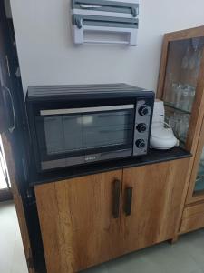 a microwave oven sitting on top of a cabinet at Ashiana in Patiāla