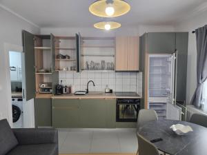 a kitchen with a table and a dining room at Apartament My Room in Curtea de Argeş