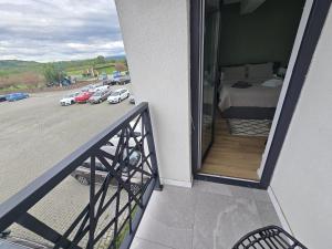 a balcony with a view of a bedroom and a parking lot at Apartament My Room in Curtea de Argeş