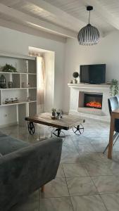 a living room with a table and a fireplace at Casa Ghjuvanna 2 chambres in Prunelli-di-Fiumorbo