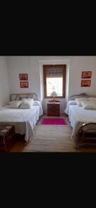 a room with three beds and a window at Eclipse Experience in Joara +5 photos