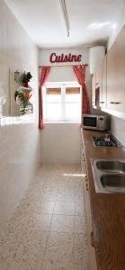a small kitchen with a sink and a window at Eclipse Experience in Joara