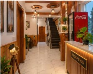 a hallway of a restaurant with a cocacola sign at Hotel The Girnaar Near Valley View Dharampur Kasauli Road in Dharampur