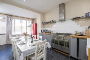 a kitchen with a table and a stove at Ty Mor in Tenby