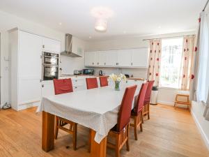 a kitchen and dining room with a table and chairs at Meadowgreen Farmhouse in Forfar