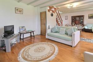 a living room with a couch and a tv at Cottage - Sleeps 4 with Log Burner & Pet Friendly in Kérien
