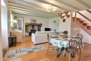 a living room with a table and a couch at Cottage - Sleeps 4 with Log Burner & Pet Friendly in Kérien