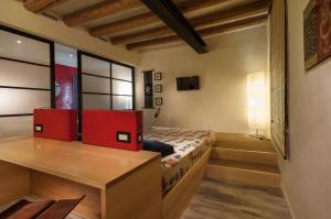 a bedroom with a bed with red dividers in it at Ca' Blanca in Castelnuovo del Garda
