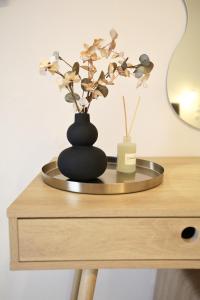 a black vase on top of a wooden table at Mochlos Studios in Mochlos +19 photos