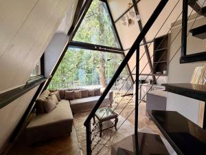 a living room with a large window in a house at The Pinecrest in Nathia Gali