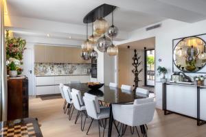 a kitchen and dining room with a black table and chairs at Montmartre Residence in Paris