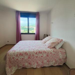 a bedroom with a bed and a window with purple curtains at Gite Aubanel' Drôme Provencale in Saint-Auban-sur-Ouvèze