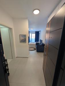a hallway with a living room and a couch at Studio apartment LISI 2 in Lezhë