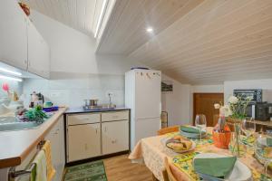 a kitchen with a table and a white refrigerator at Ca Contina in Val Verzasca - Happy Rentals in Frasco