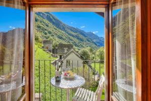 a view from a balcony with a table and chairs at Ca Contina in Val Verzasca - Happy Rentals in Frasco