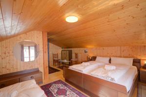 a bedroom with a large bed in a wooden room at Ca Contina in Val Verzasca - Happy Rentals in Frasco