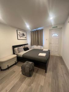 a bedroom with a large bed and a window at Brigstock 9 in Thornton Heath