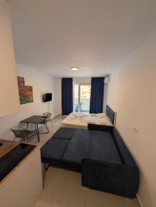 a bedroom with a large bed and a table at Studio apartment LISI 2 in Lezhë