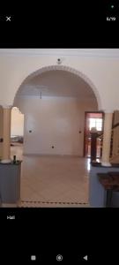 a large room with an arch in the middle of it at Dar ojkak in Essaouira