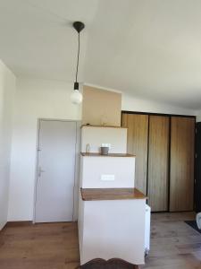 a kitchen with white cabinets and a white refrigerator at Gite Aubanel' Drôme Provencale in Saint-Auban-sur-Ouvèze