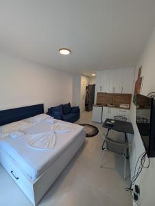 a bedroom with a bed and a living room at Studio apartment LISI 2 in Lezhë