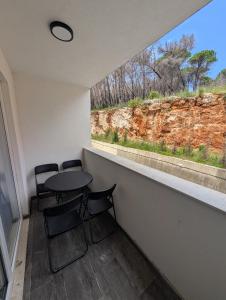 a room with a table and chairs and a window at Studio apartment LISI 2 in Lezhë