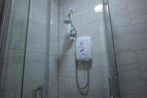 a shower with a shower head in a bathroom at Deaf Property - Woolwich Elizabeth Line Studios in Woolwich +81 photos