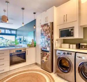 a kitchen with a dishwasher and a washer at Umdloti Holiday Resort 208 in Umdloti
