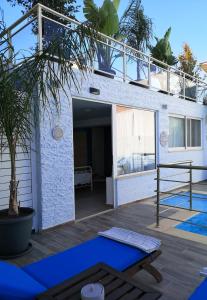 a house with a blue yoga mat on a patio at Valantas Garden Suite in Lartos