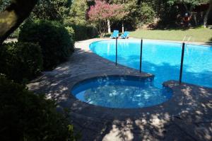 a large swimming pool with a blue pool at Hotel Can Ribalta in San Antonio de Vilamajor