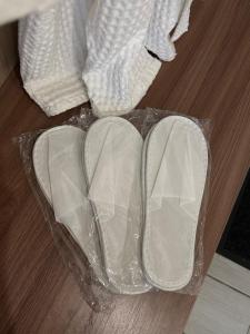 a pair of white shoes sitting on a wooden floor at Amari in Uralʼskiy Prigorodnyy