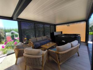 a living room with a couch and a table at Au Ch'ti Suisse in Autechaux