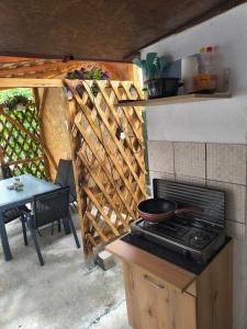 an outdoor kitchen with a stove and a table at Casa Tesmao in Constanţa