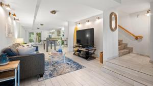 a living room with a couch and a tv at 907 Mariners Club in Key Largo