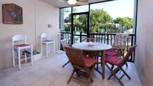 a dining room with a table and chairs on a balcony at B105 Moon Bay in Key Largo