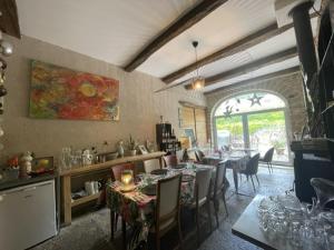 a kitchen and dining room with tables and chairs at L'Entre-Coeur in Ménétru-le-Vignoble