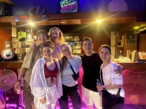 a group of people posing for a picture in a bar at La Lagartija Iquitos in Iquitos